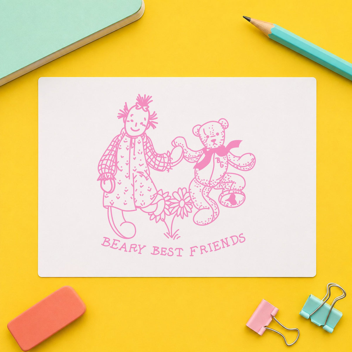 Beary Best Friends Bear and Doll Rubber Stamp impression in pink ink on white paper in a styled craft setting.