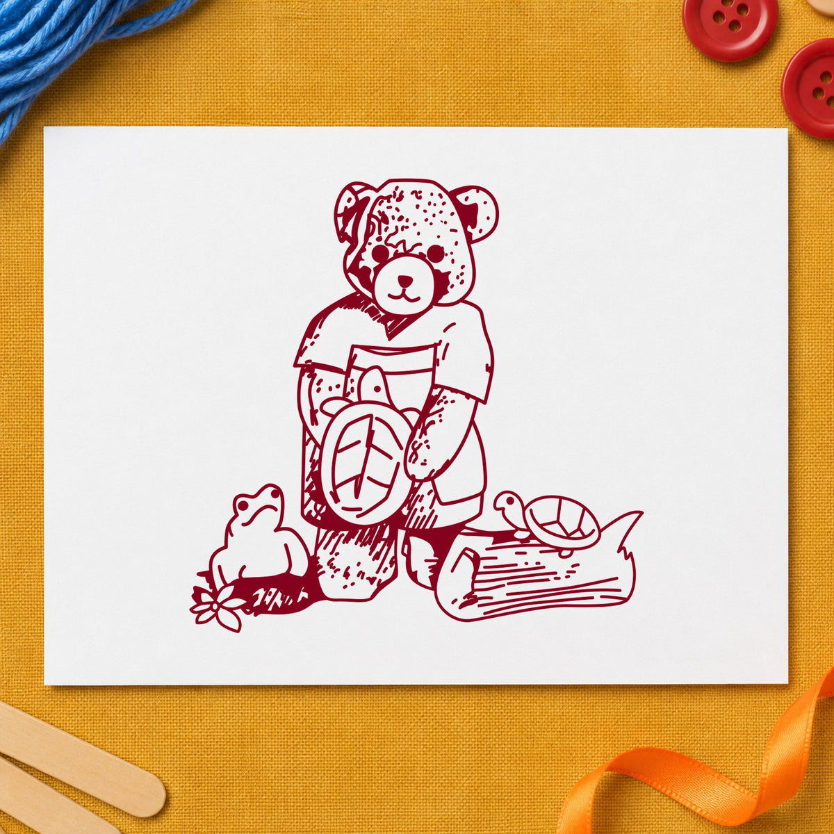 Bear with Turtles Rubber Stamp impression in burgundy ink on white paper in a styled craft setting.