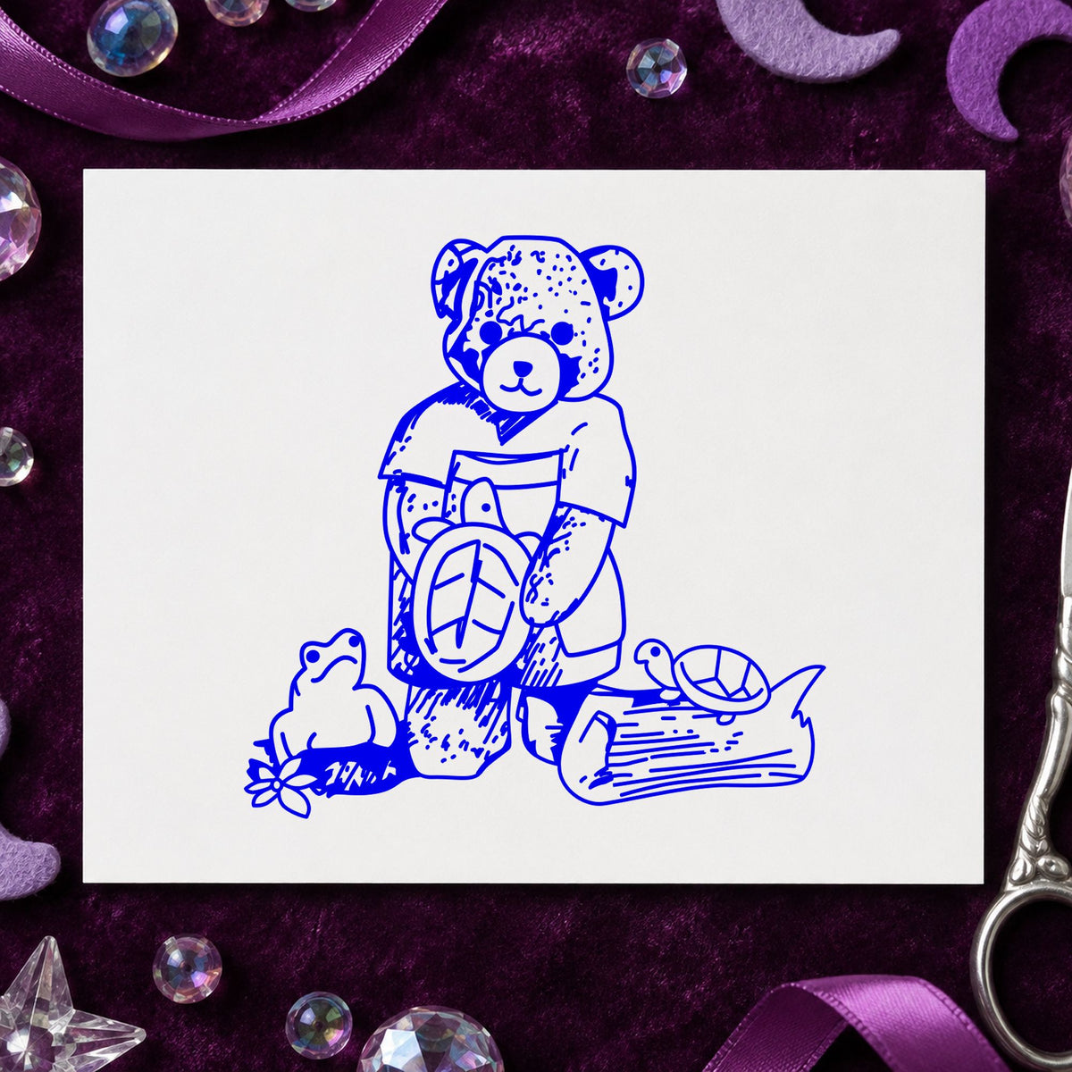 Bear with Turtles Rubber Stamp impression in blue ink on white paper in a styled craft setting.