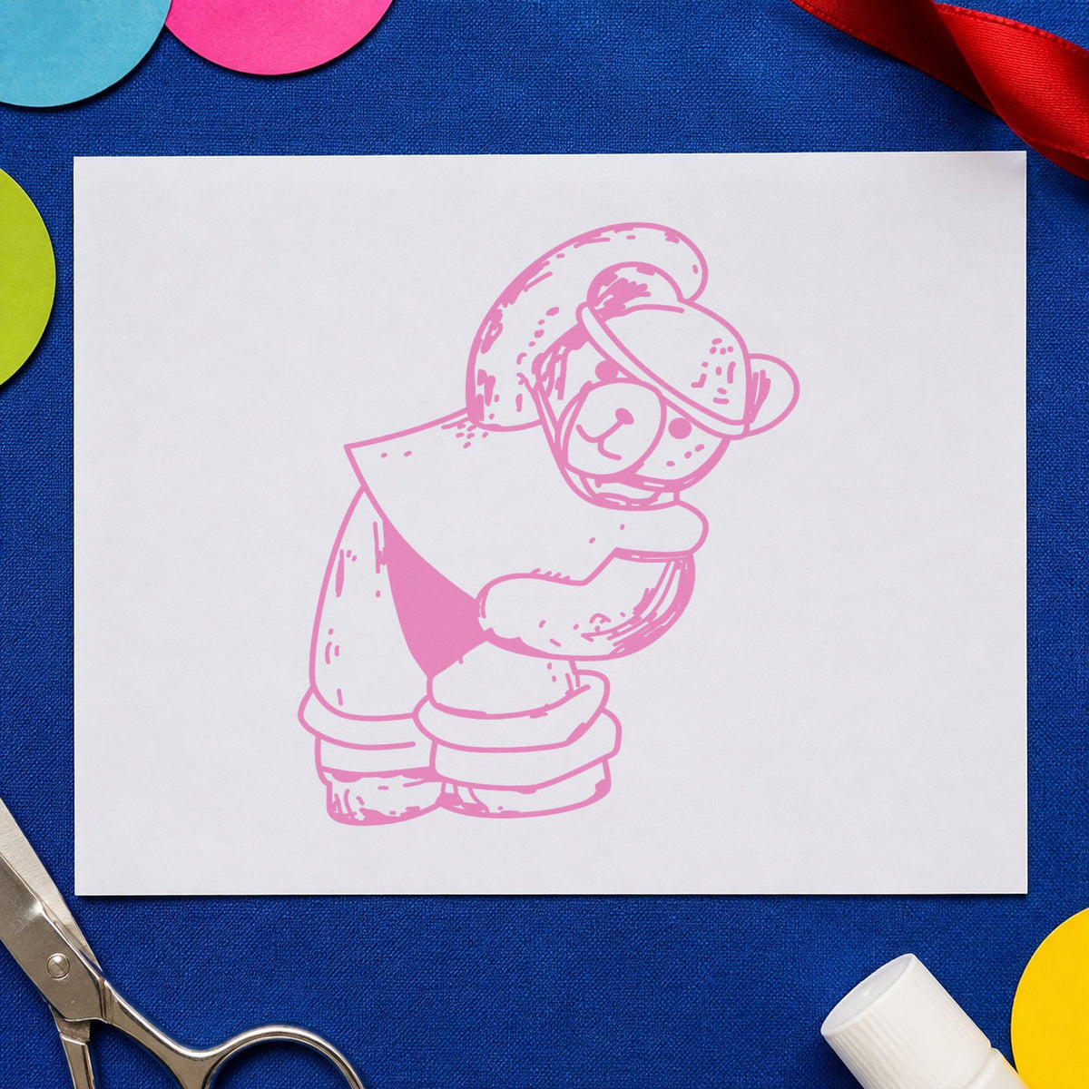 Workout Bear in Headband Rubber Stamp impression in pink ink on white paper in a styled craft setting.
