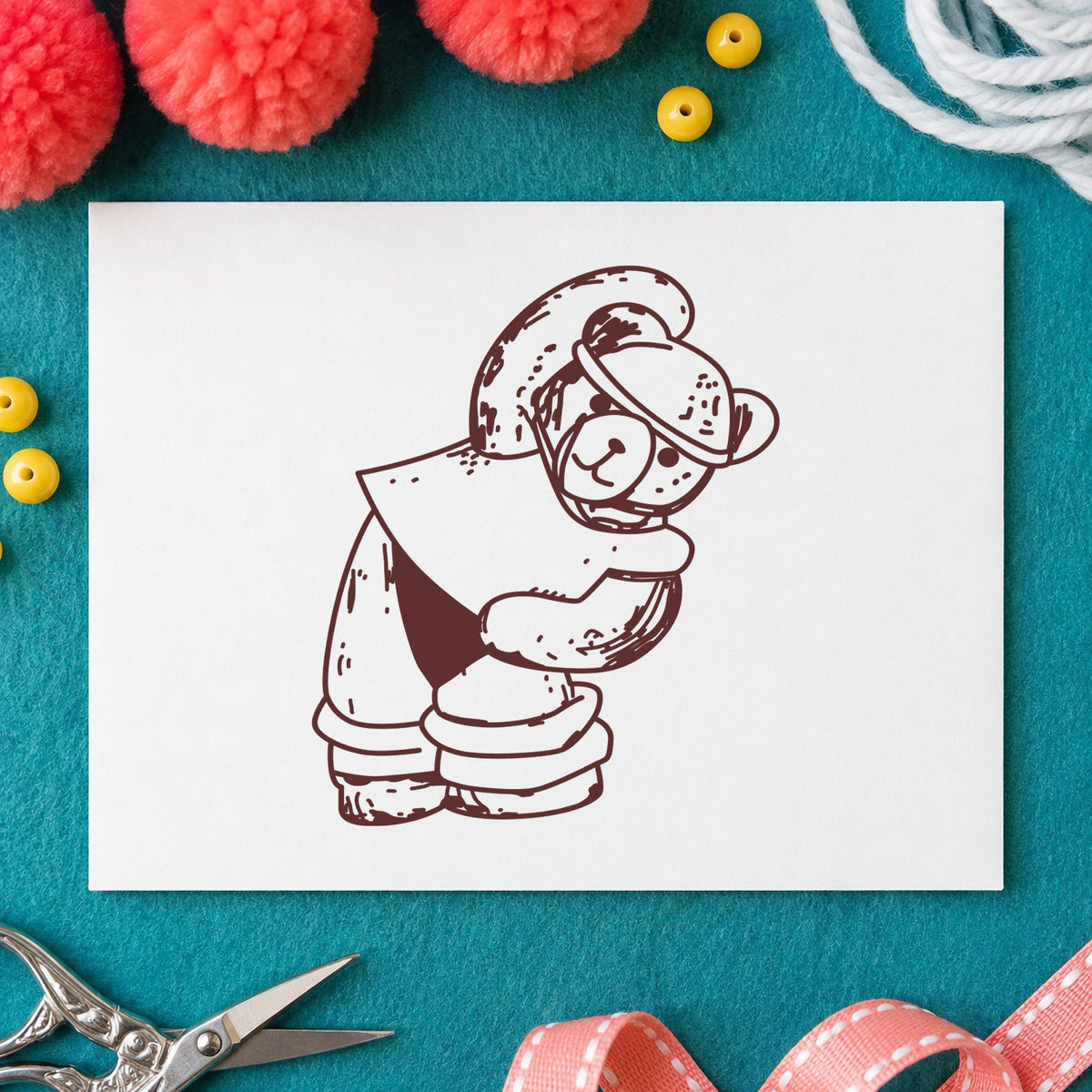 Workout Bear in Headband Rubber Stamp impression in brown ink on white paper in a styled craft setting.