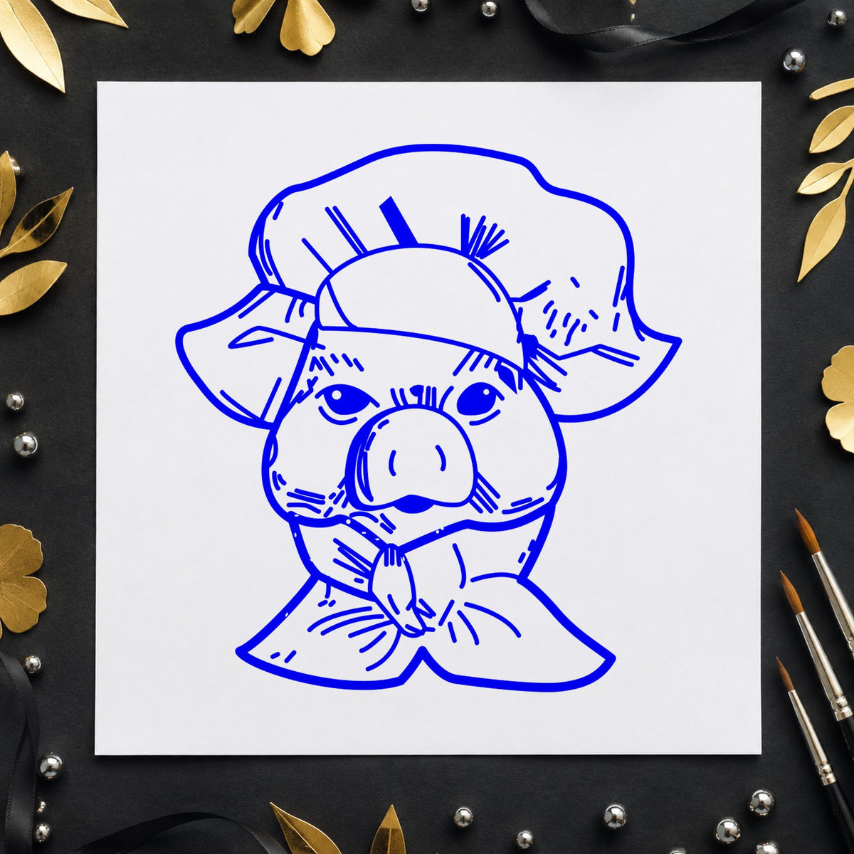 Chef Pig Portrait Rubber Stamp impression in blue ink on white paper in a styled craft setting.