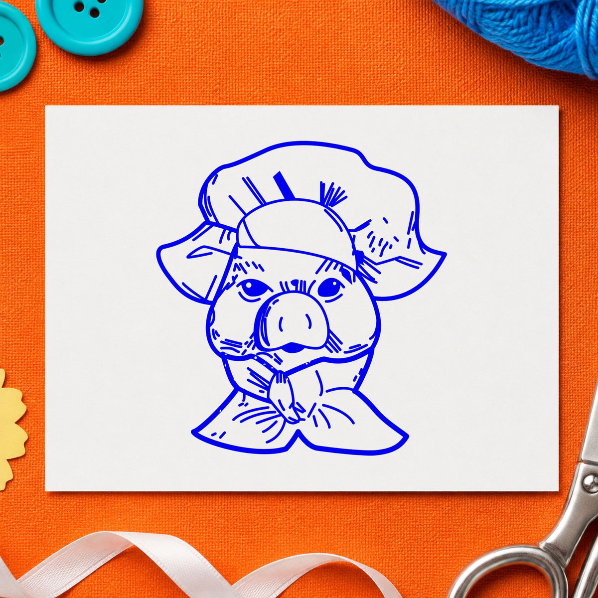 Blue pig craft stamp impression featuring the chef pig portrait design on white paper.