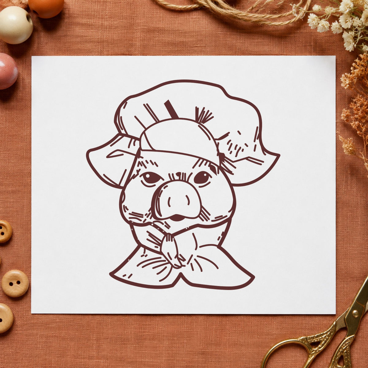 Chef Pig Portrait Rubber Stamp impression in brown ink on white paper in a styled craft setting.
