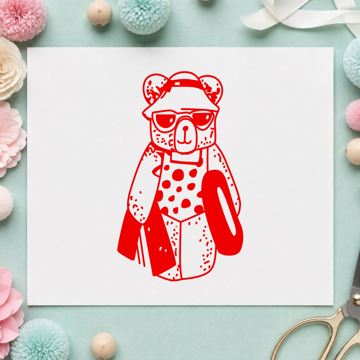 Bear with Inner Tube Rubber Stamp impression in red ink on white paper in a styled craft setting.