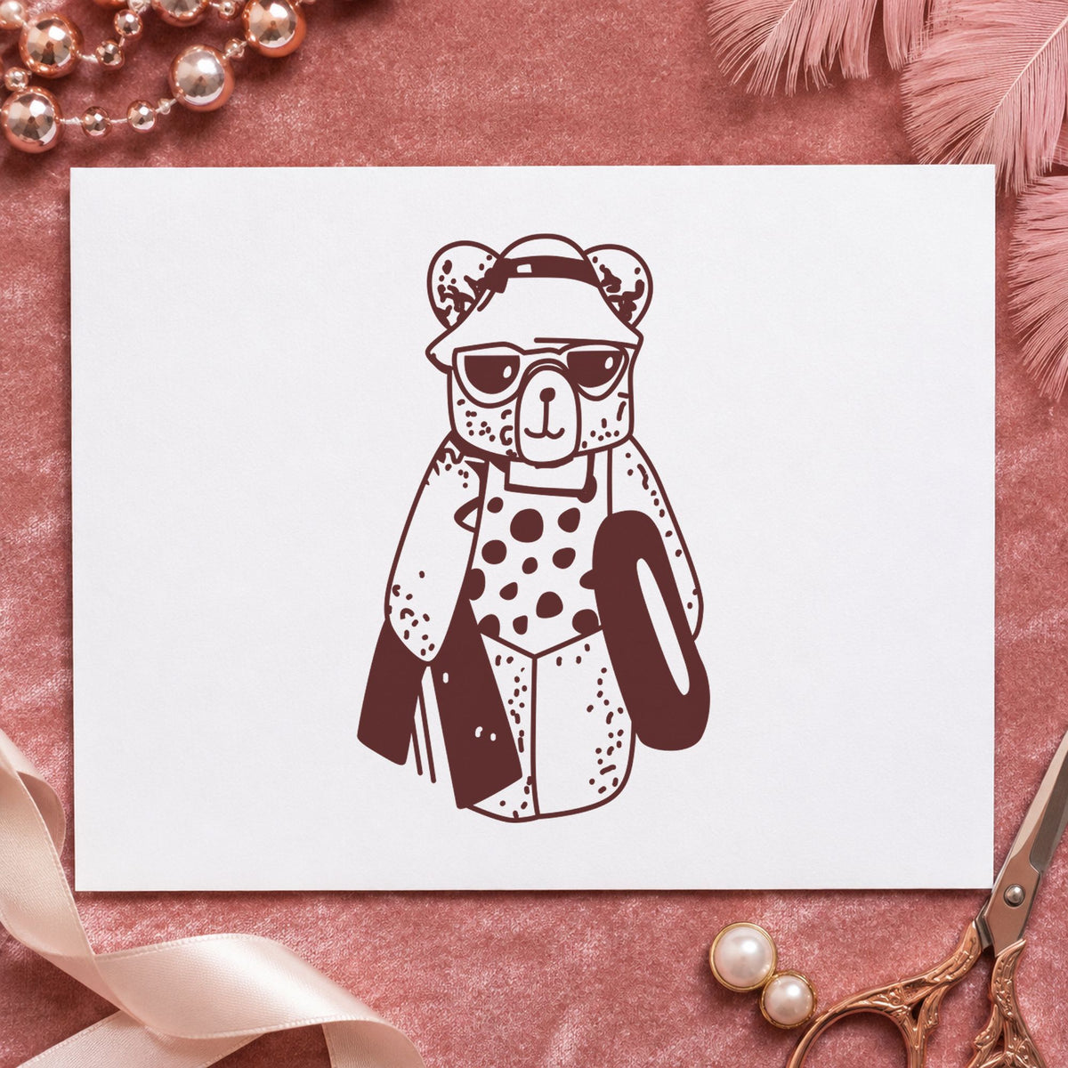 Bear with Inner Tube Rubber Stamp impression in brown ink on white paper in a styled craft setting.