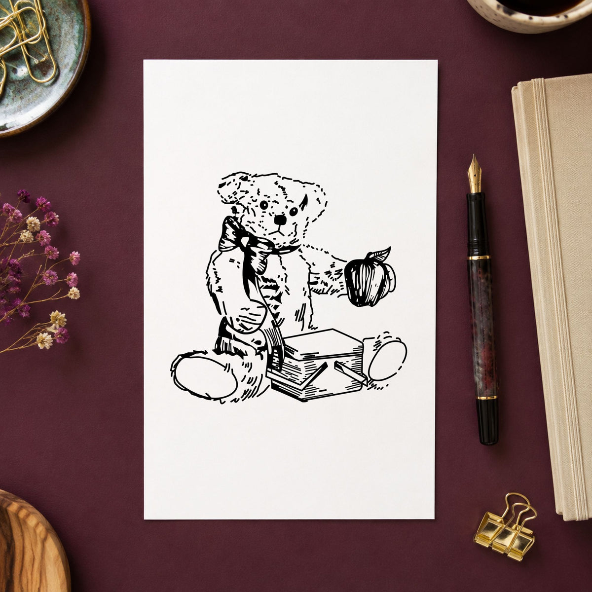 Bear with Picnic Basket and Apple Rubber Stamp impression in black ink on white paper in a styled craft setting.