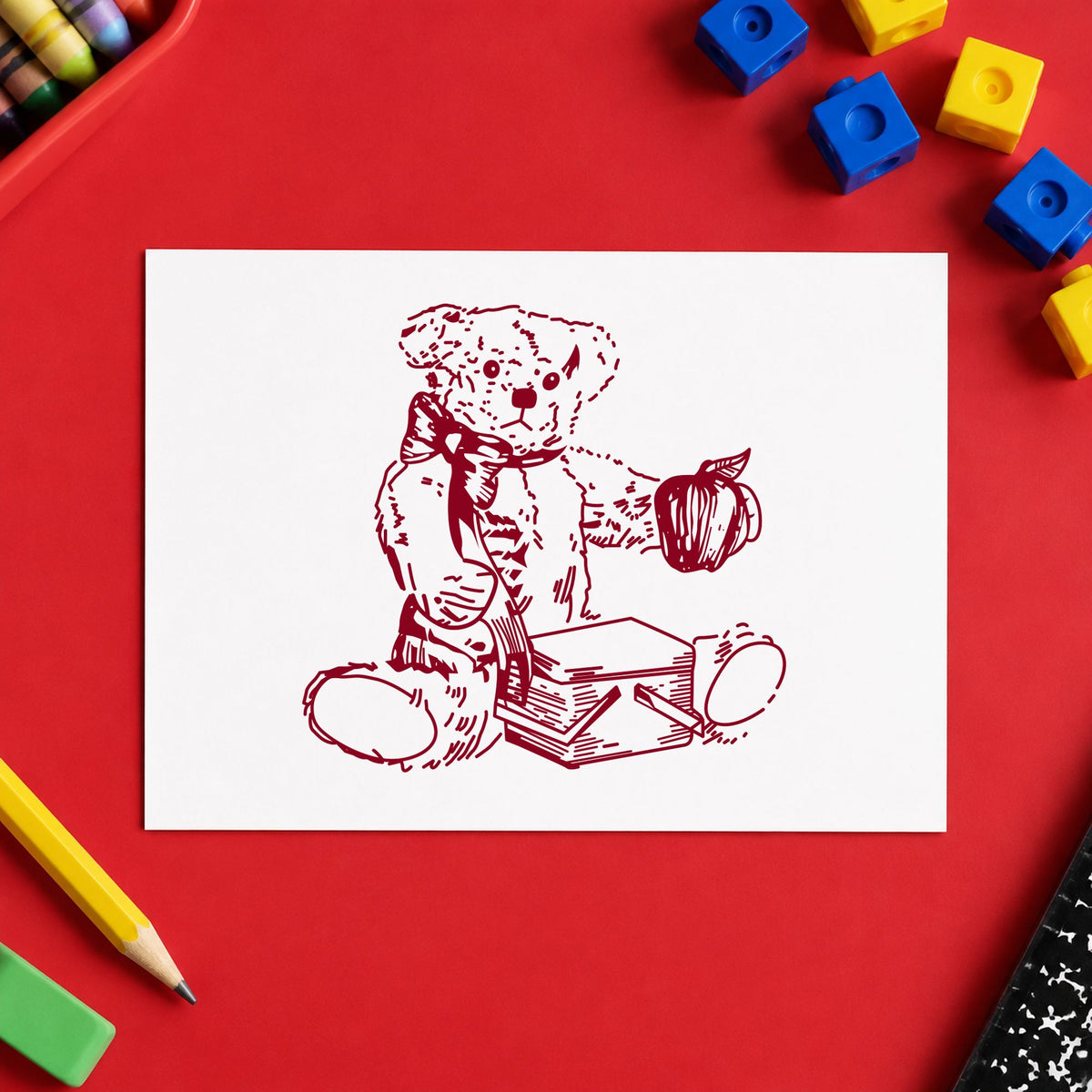 Bear with Picnic Basket and Apple Rubber Stamp impression in burgundy ink on white paper in a styled craft setting.