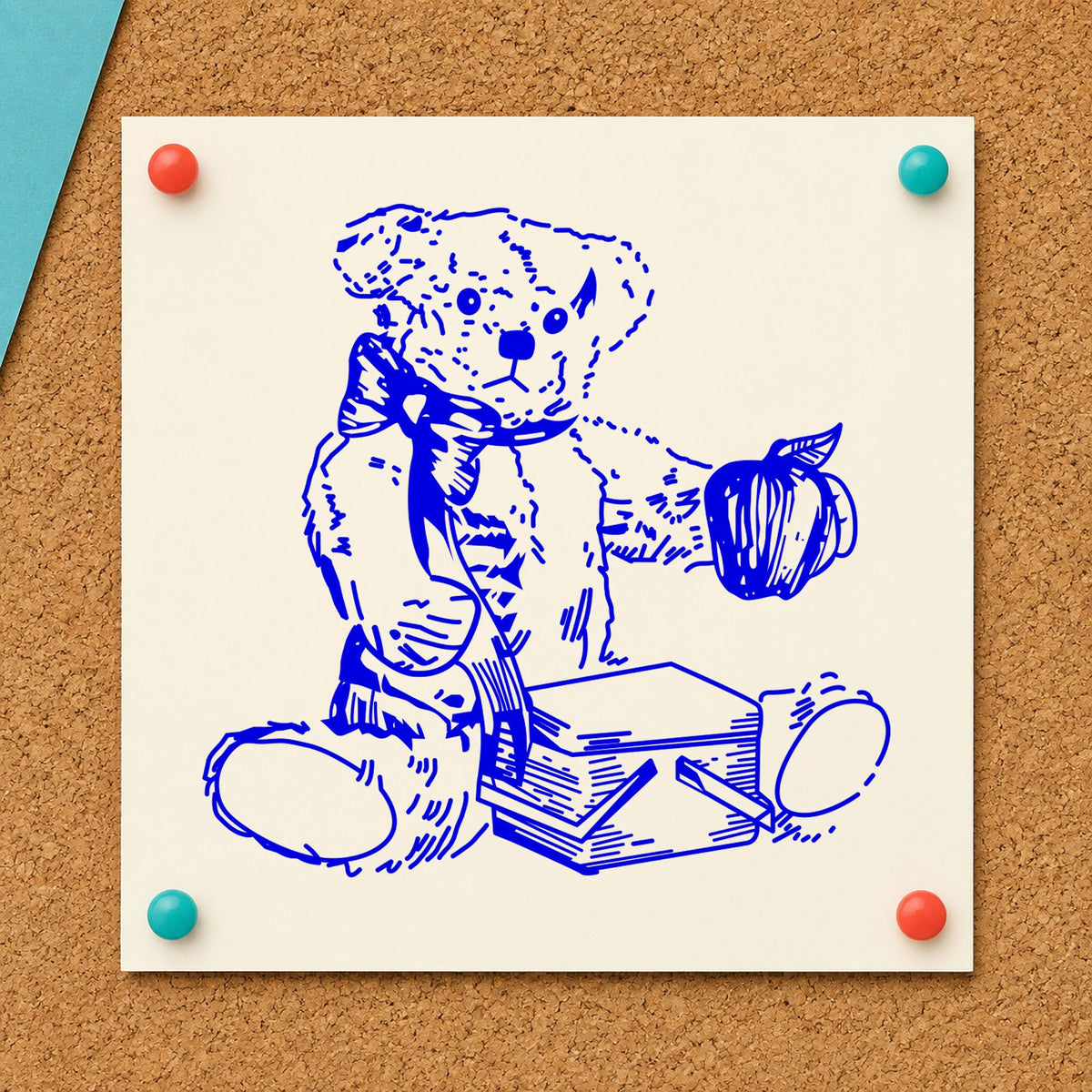 Blue teddy bear paper craft stamp impression featuring the bear with picnic basket and apple design on white paper.
