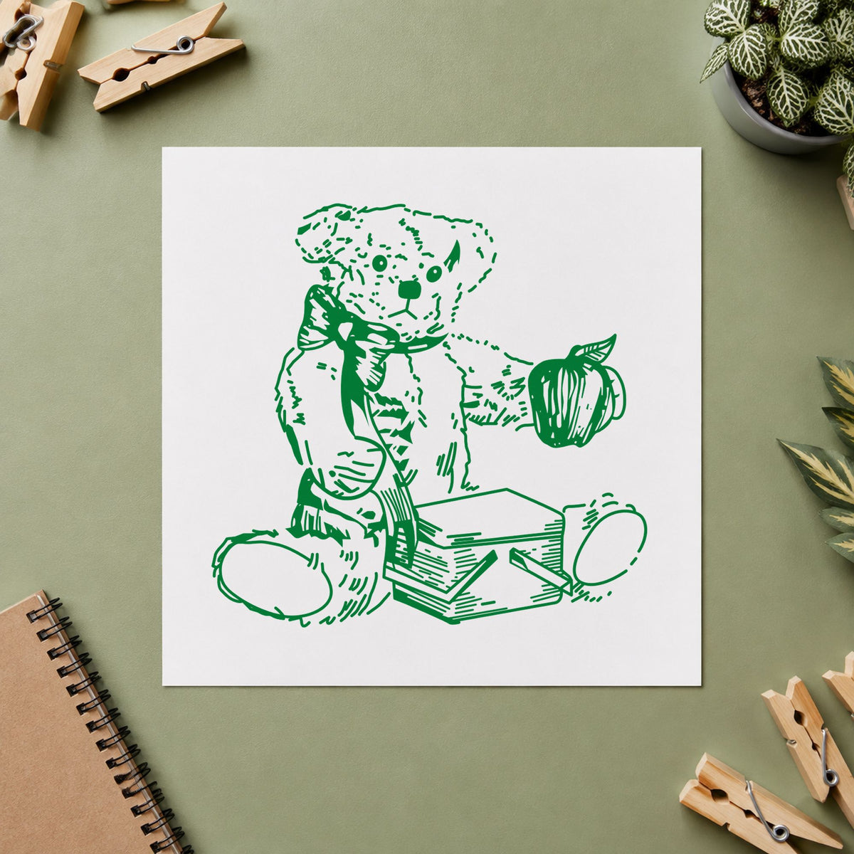 Bear with Picnic Basket and Apple Rubber Stamp impression in green ink on white paper in a styled craft setting.