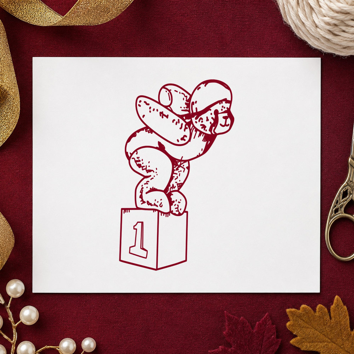 Diving Bear on Starting Block Rubber Stamp impression in burgundy ink on white paper in a styled craft setting.