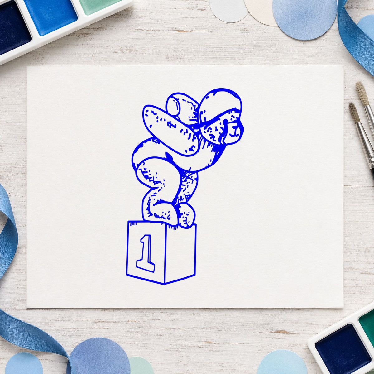 Diving Bear on Starting Block Rubber Stamp impression in blue ink on white paper in a styled craft setting.