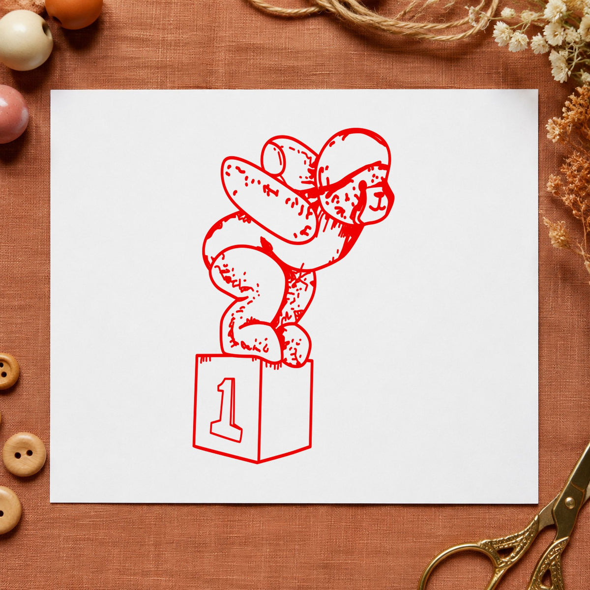 Diving Bear on Starting Block Rubber Stamp impression in red ink on white paper in a styled craft setting.