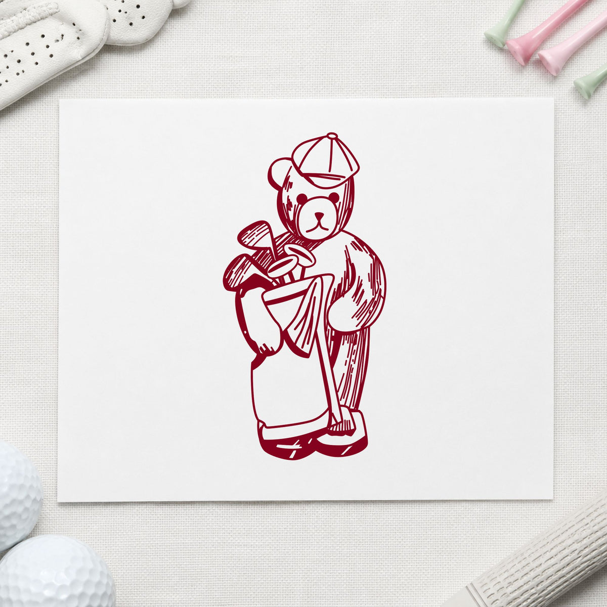Golf Bear with Clubs Rubber Stamp impression in burgundy ink on white paper in a styled craft setting.