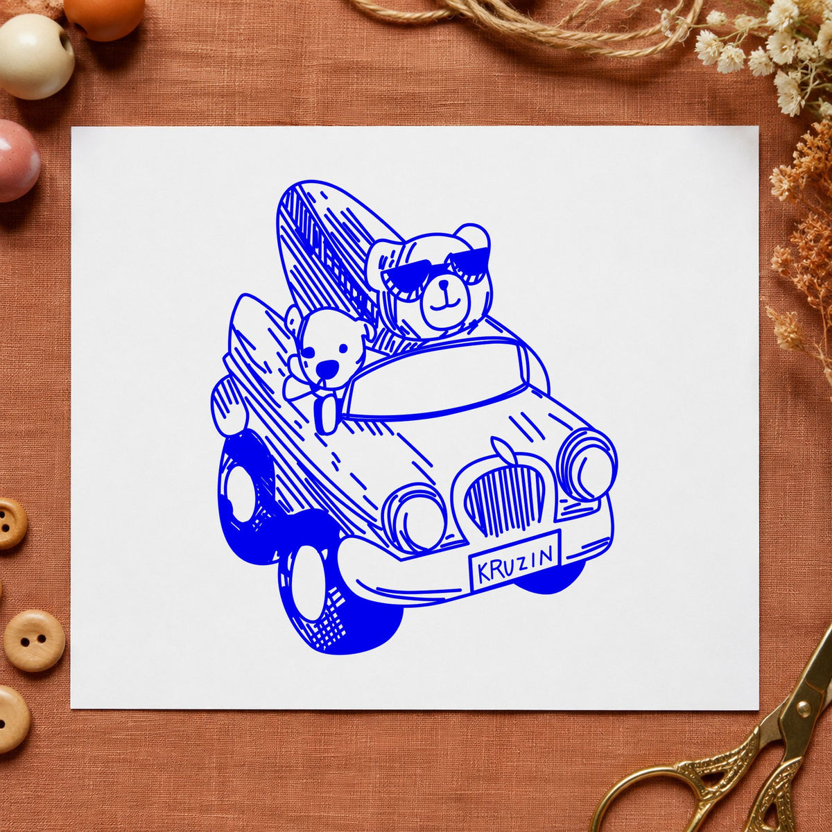 Surfboard Bear in Convertible Rubber Stamp impression in blue ink on white paper in a styled craft setting.