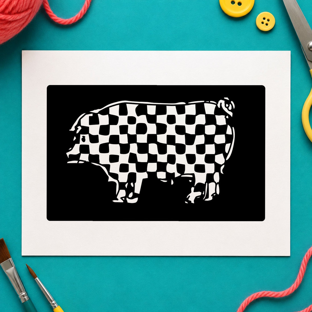 Checkered Pig Block Rubber Stamp impression in black ink on white paper in a styled craft setting.