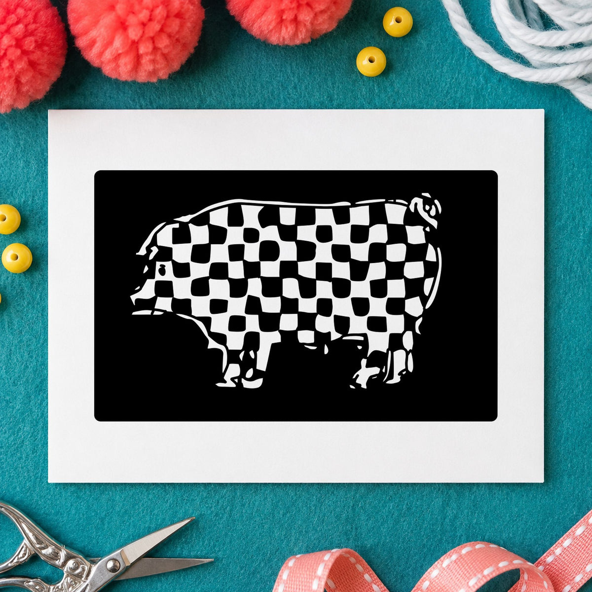 Black impression from a pig rubber stamp, featuring the checkered pig block design on white paper.