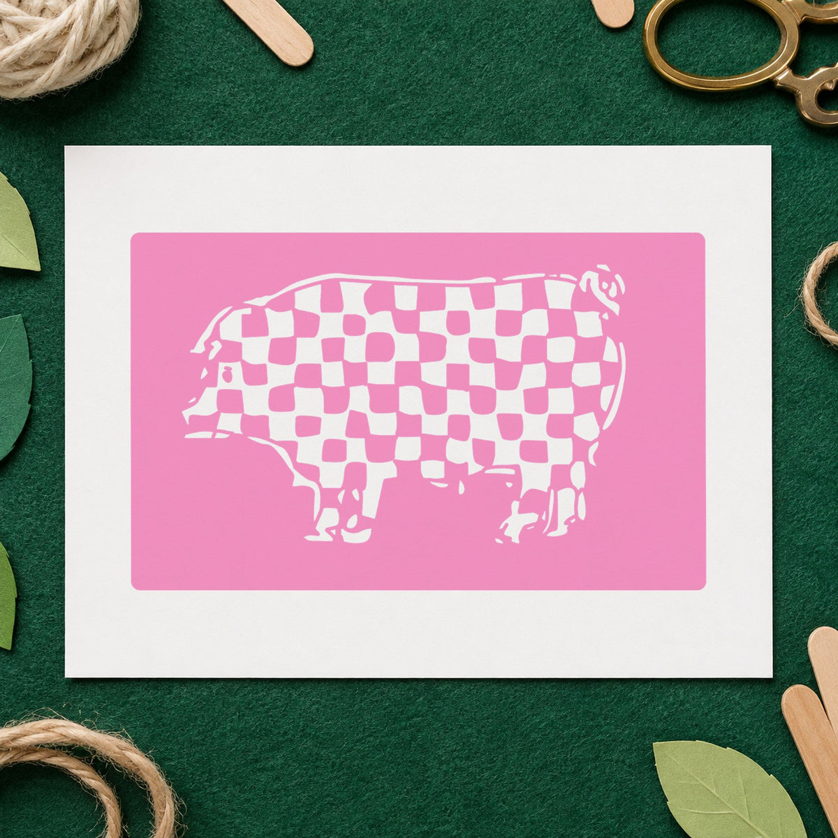 Checkered Pig Block Rubber Stamp impression in pink ink on white paper in a styled craft setting.
