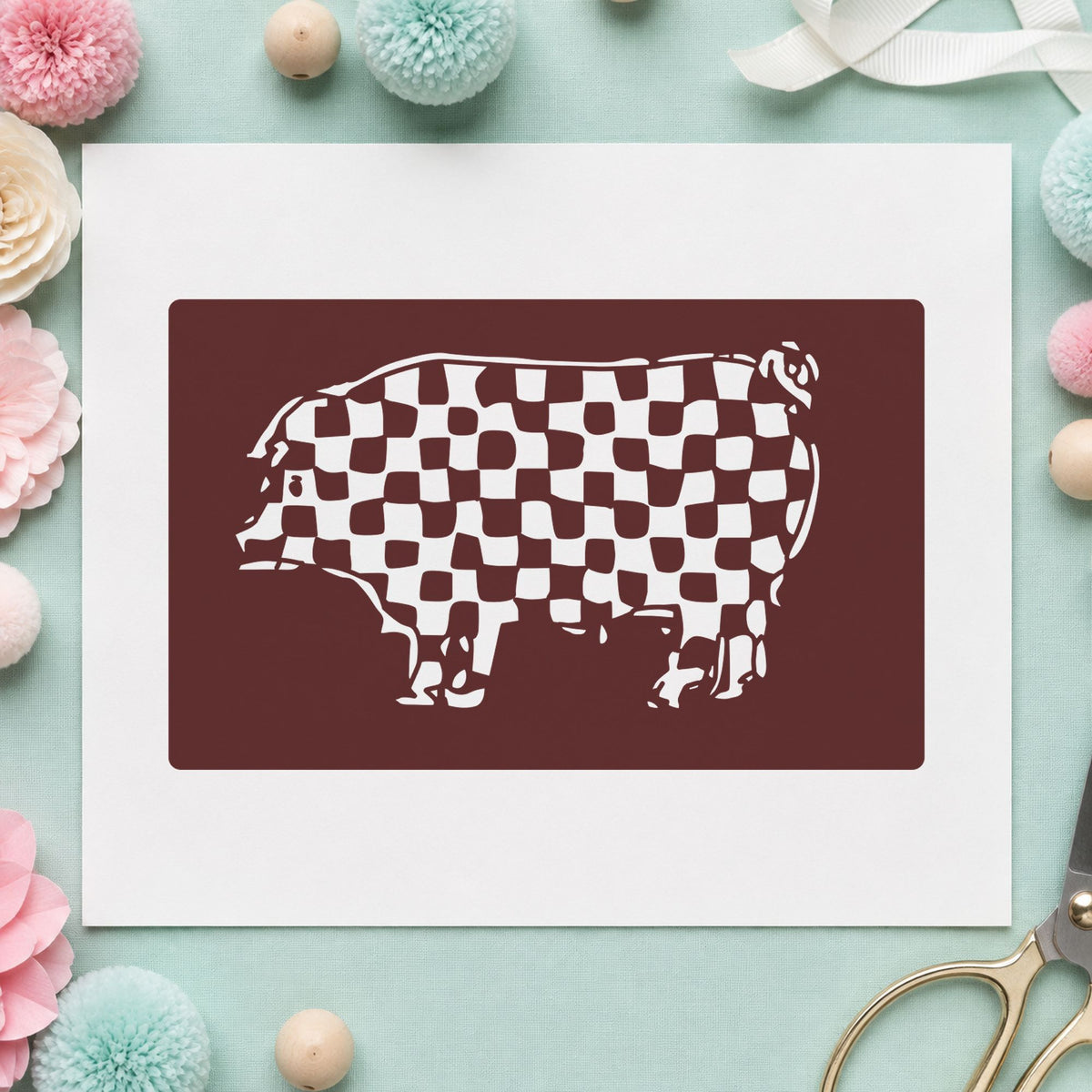 Checkered Pig Block Rubber Stamp impression in brown ink on white paper in a styled craft setting.