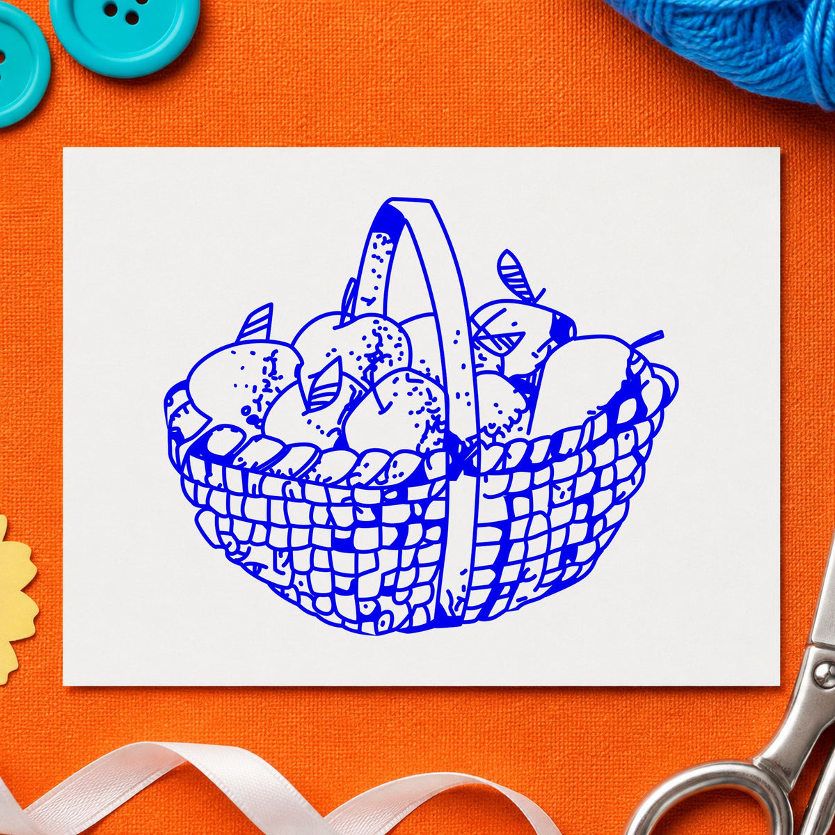 Blue harvest craft stamp impression featuring the round apple basket design on white paper.