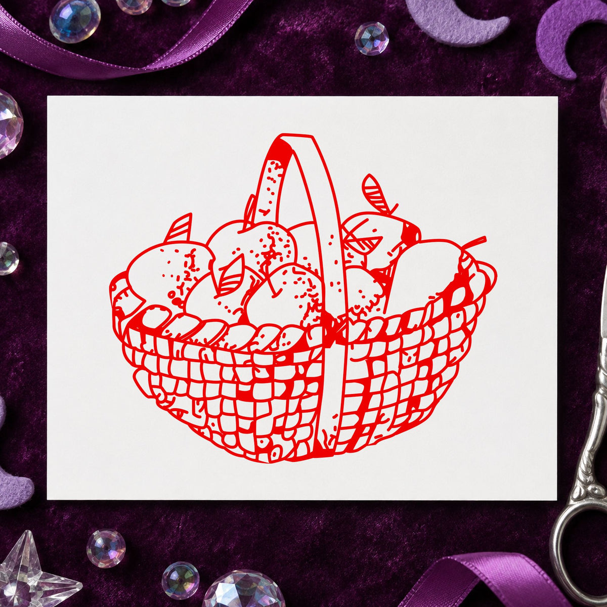 Round Apple Basket Rubber Stamp impression in red ink on white paper in a styled craft setting.