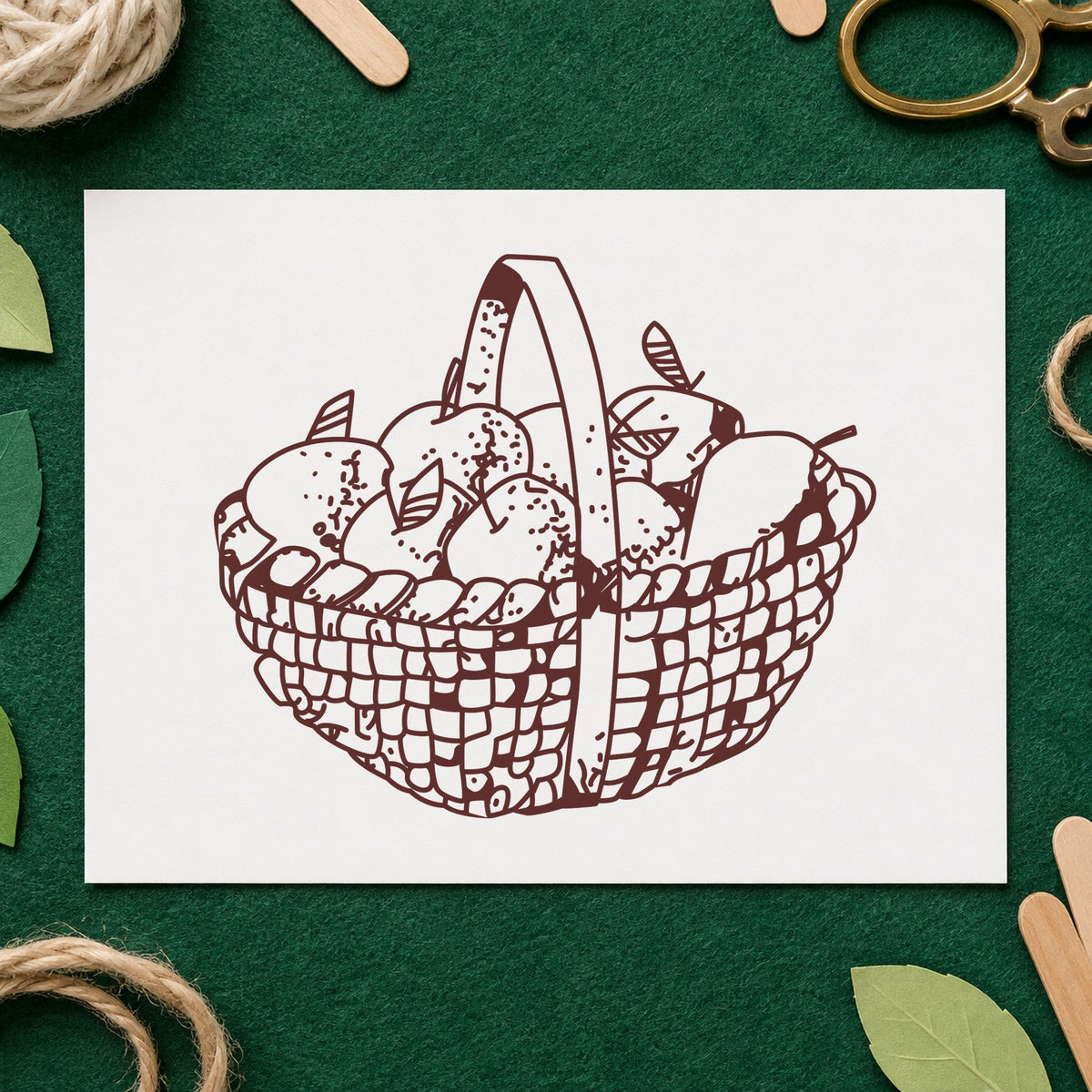 Round Apple Basket Rubber Stamp impression in brown ink on white paper in a styled craft setting.