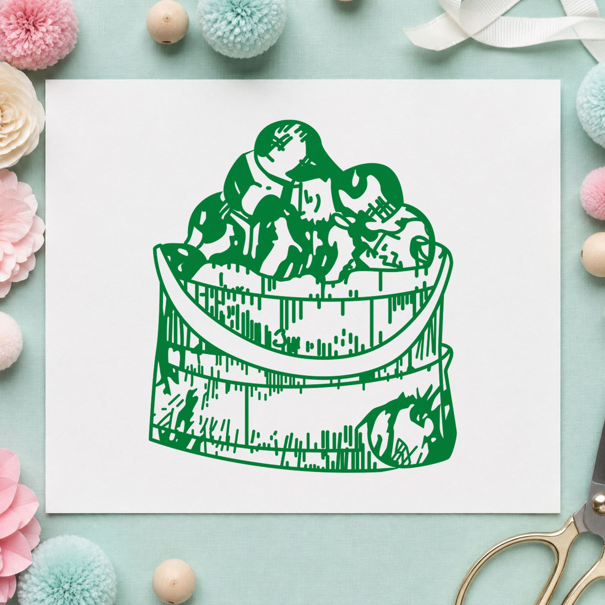 Wooden Bucket of Apples Rubber Stamp impression in green ink on white paper in a styled craft setting.