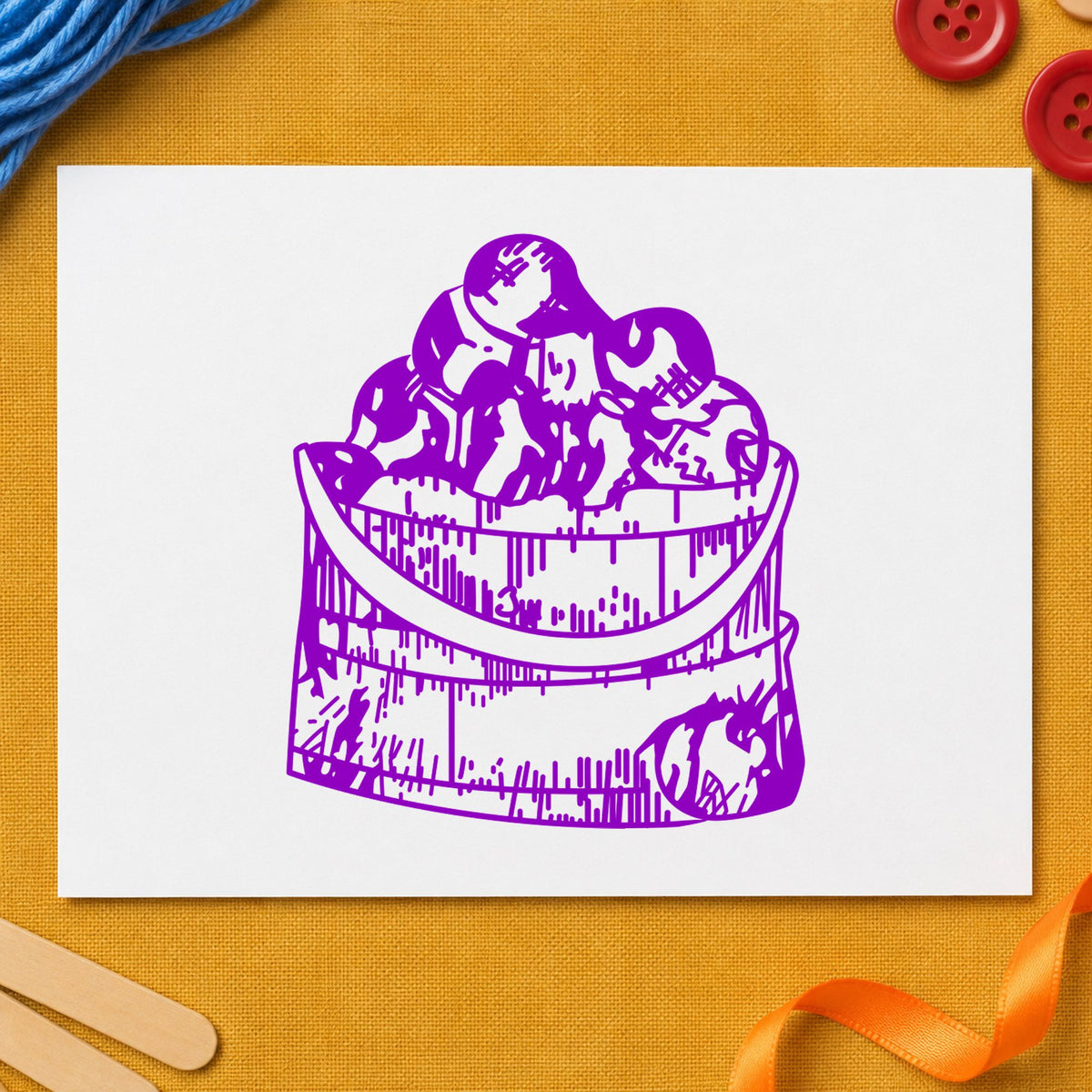 Wooden Bucket of Apples Rubber Stamp impression in purple ink on white paper in a styled craft setting.