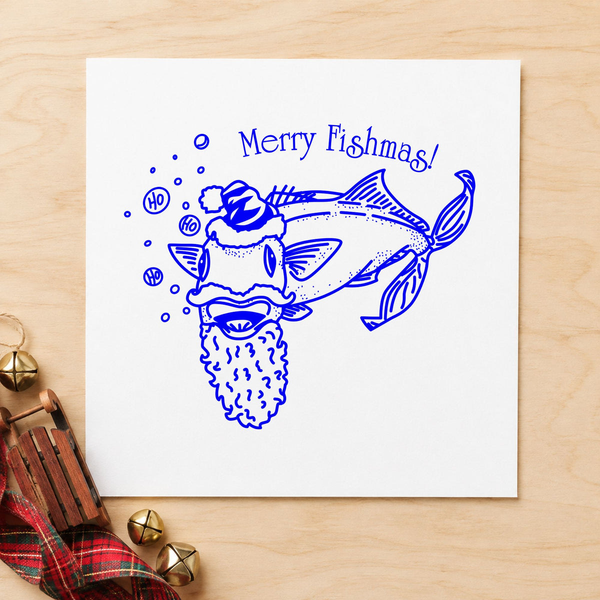 Blue funny holiday card stamp impression featuring the merry fishmas catfish design on white paper.