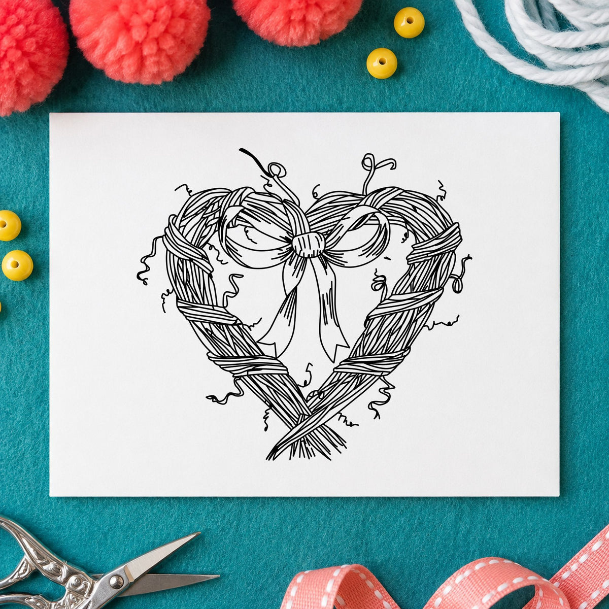 Black impression from a heart wreath stamp, featuring the heart wreath with bow design on white paper.