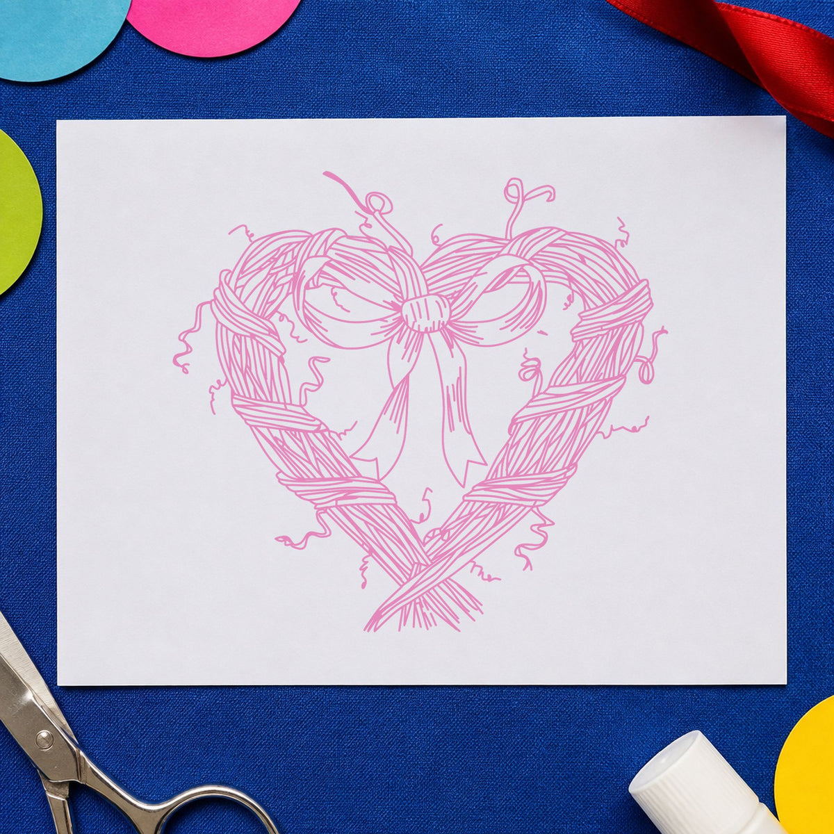 Heart Wreath with Bow Rubber Stamp impression in pink ink on white paper in a styled craft setting.