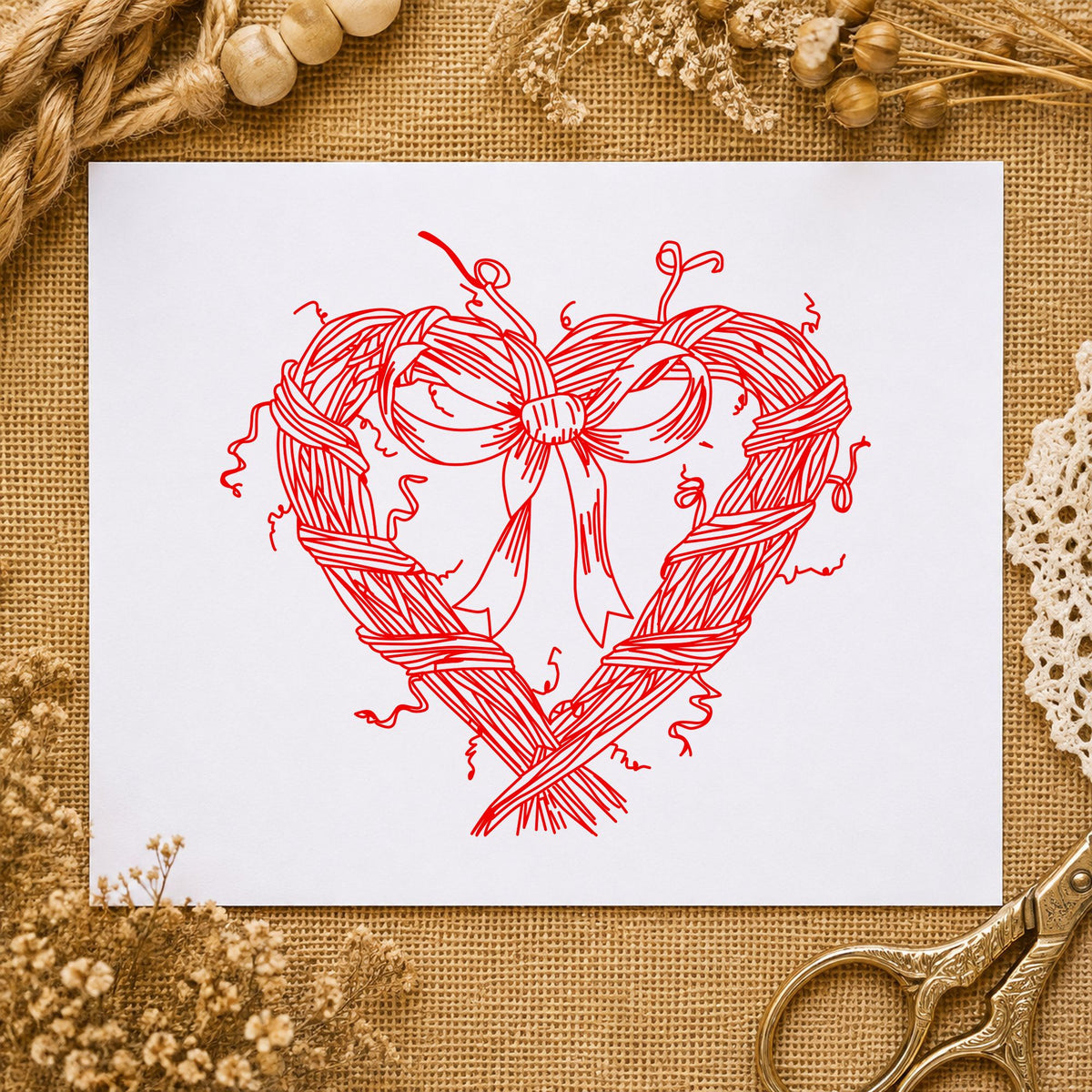 Heart Wreath with Bow Rubber Stamp impression in red ink on white paper in a styled craft setting.