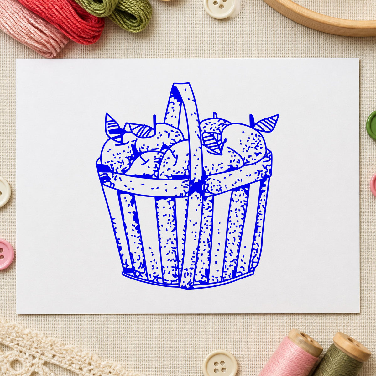 Blue fall card making stamp impression featuring the slatted apple basket design on white paper.