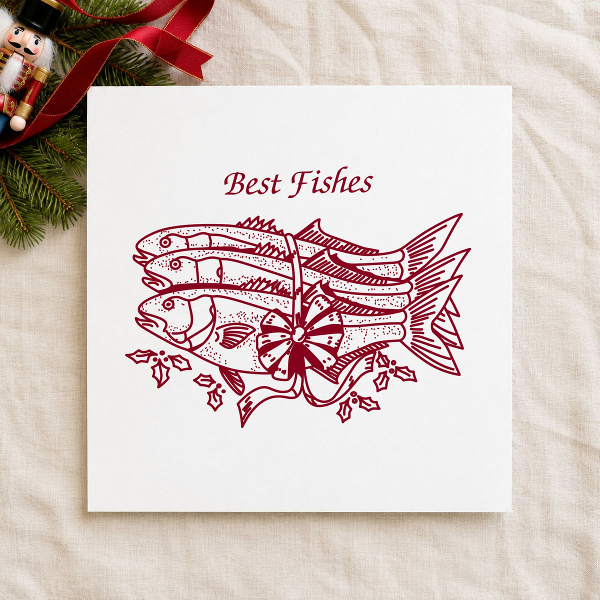 Best Fishes with Poinsettias Rubber Stamp impression in burgundy ink on white paper in a styled craft setting.