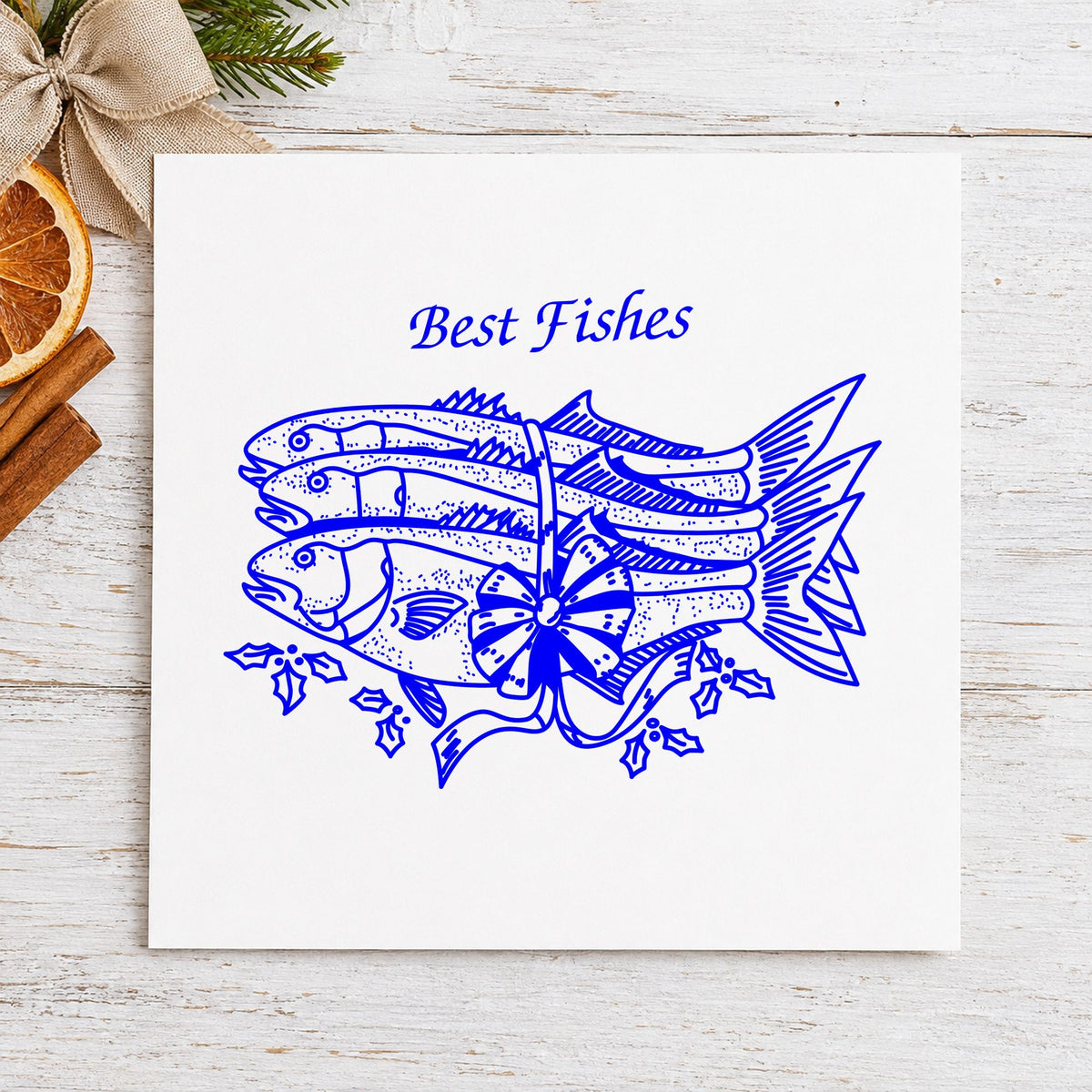 Best Fishes with Poinsettias Rubber Stamp impression in blue ink on white paper in a styled craft setting.