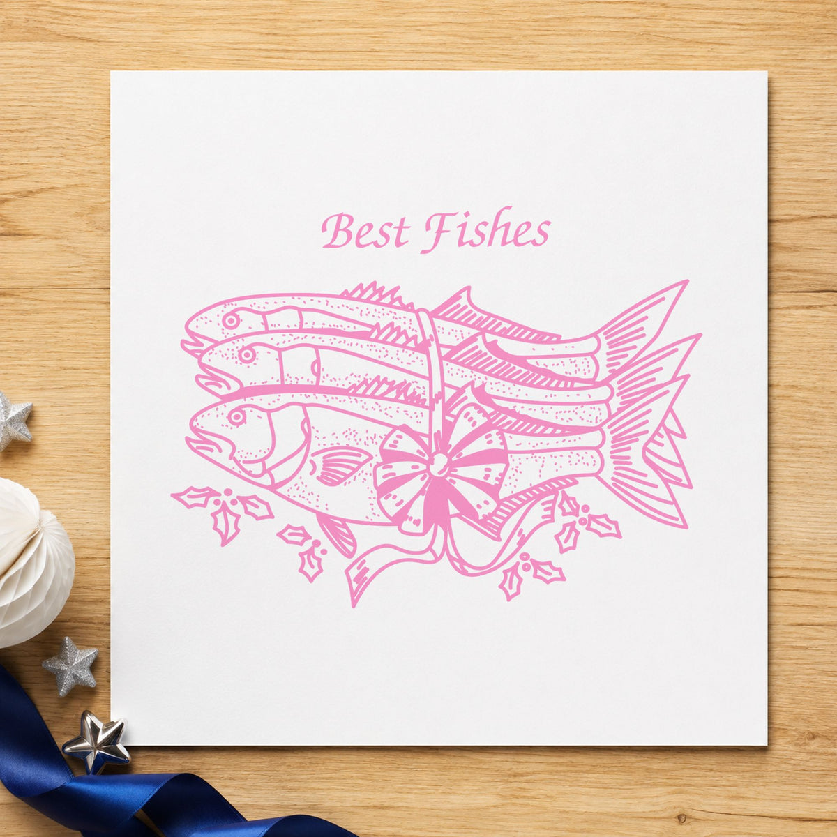 Best Fishes with Poinsettias Rubber Stamp impression in pink ink on white paper in a styled craft setting.