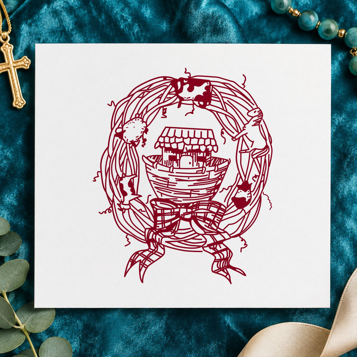 Ark in Wreath Rubber Stamp impression in burgundy ink on white paper in a styled craft setting.