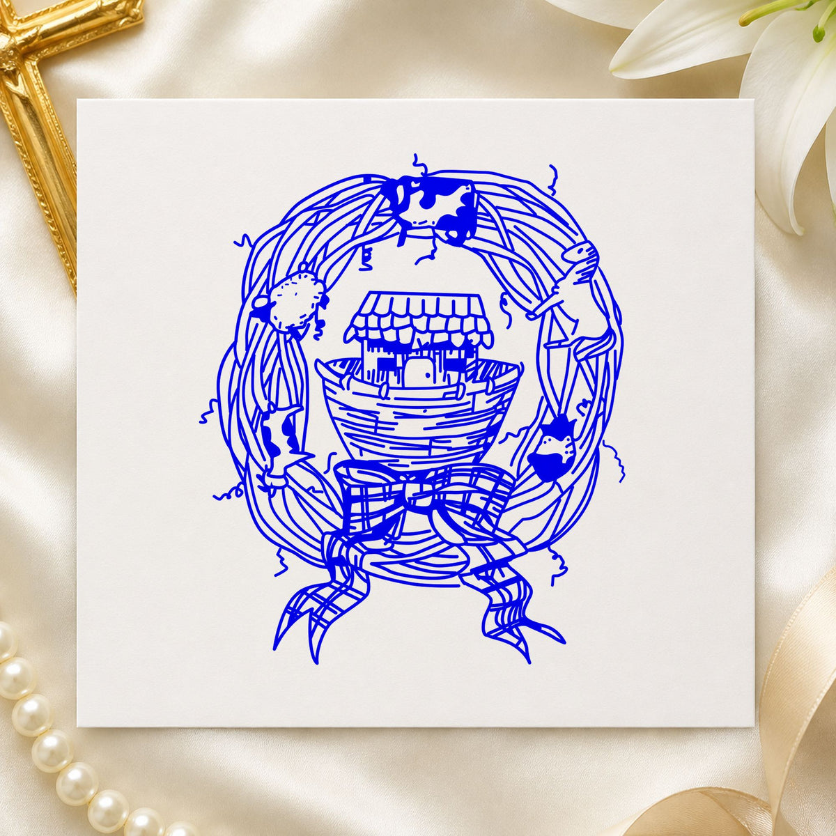 Ark in Wreath Rubber Stamp impression in blue ink on white paper in a styled craft setting.