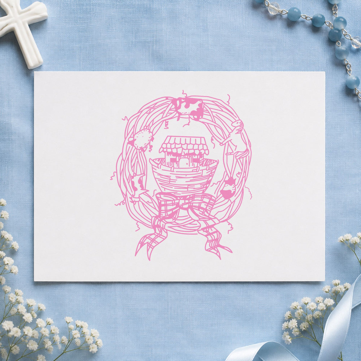 Ark in Wreath Rubber Stamp impression in pink ink on white paper in a styled craft setting.