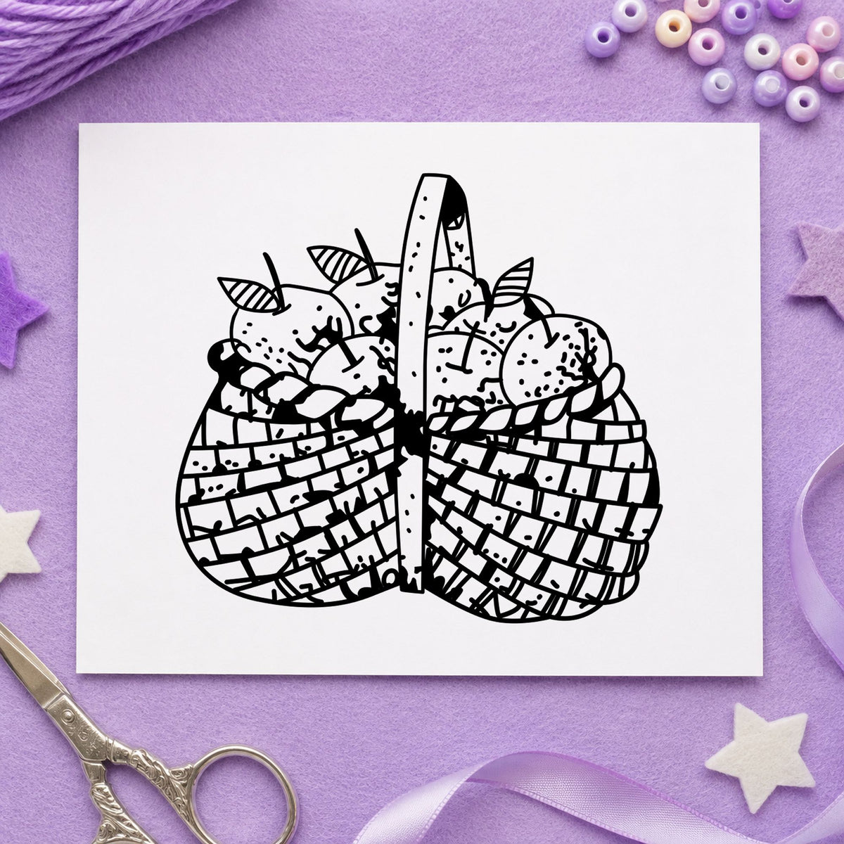 Basket Brimming with Apples Rubber Stamp impression in black ink on white paper in a styled craft setting.