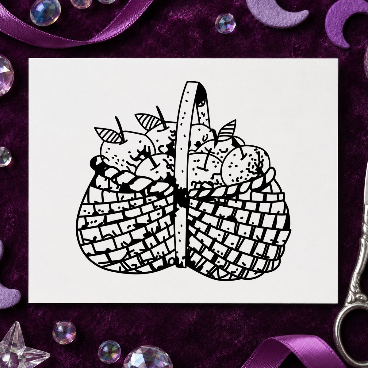 Black impression from a fruit rubber stamp, featuring the basket brimming with apples design on white paper.