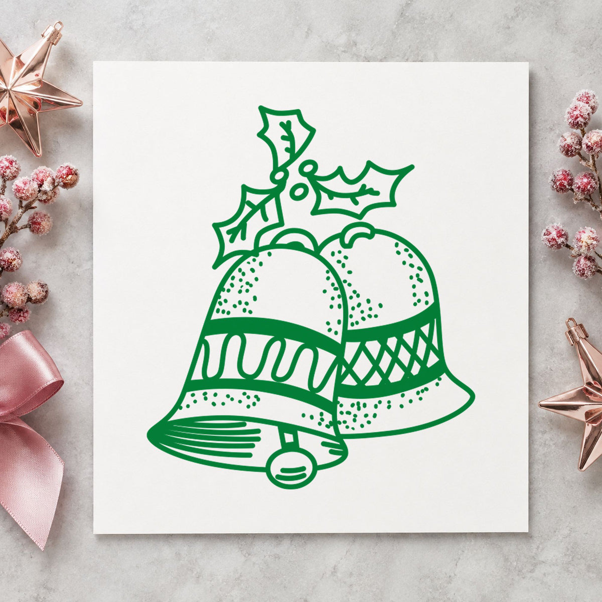 Christmas Bells with Mistletoe Rubber Stamp impression in green ink on white paper in a styled craft setting.