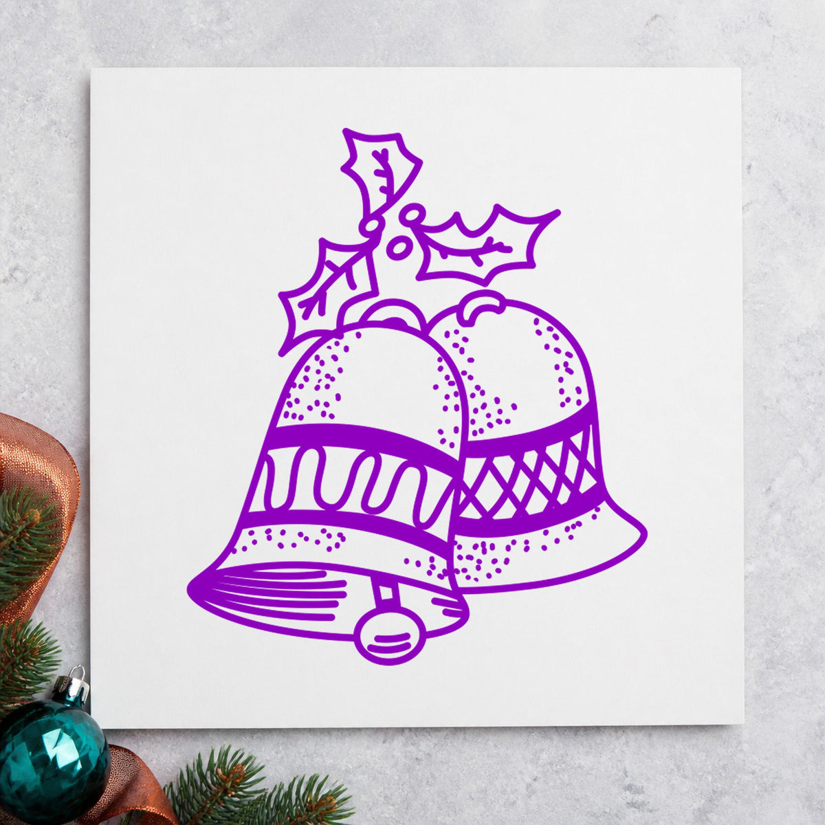 Christmas Bells with Mistletoe Rubber Stamp impression in purple ink on white paper in a styled craft setting.