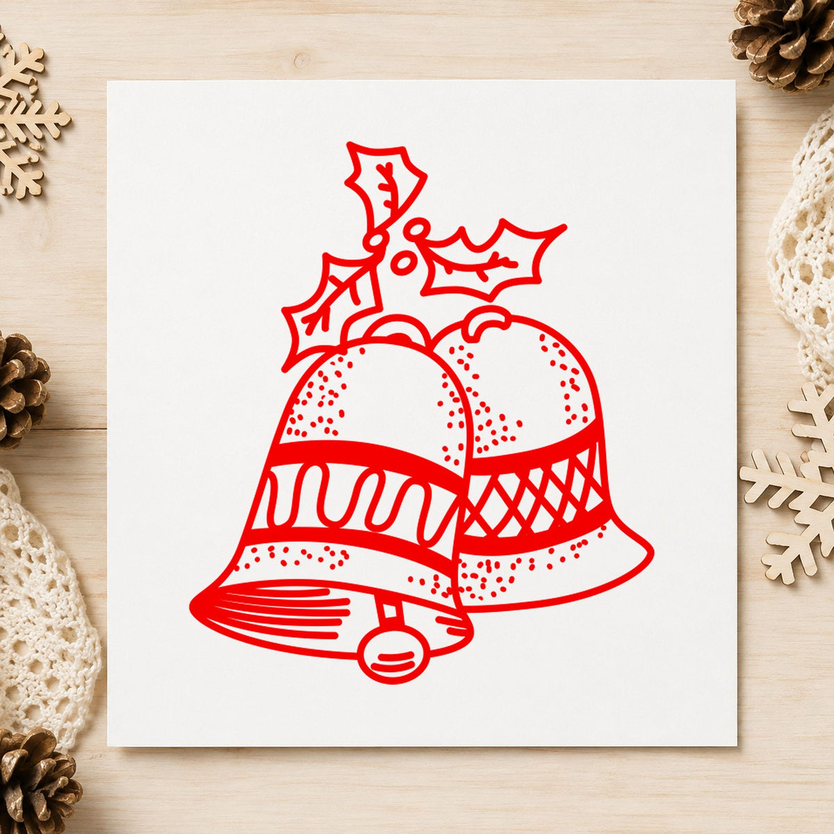 Christmas Bells with Mistletoe Rubber Stamp impression in red ink on white paper in a styled craft setting.