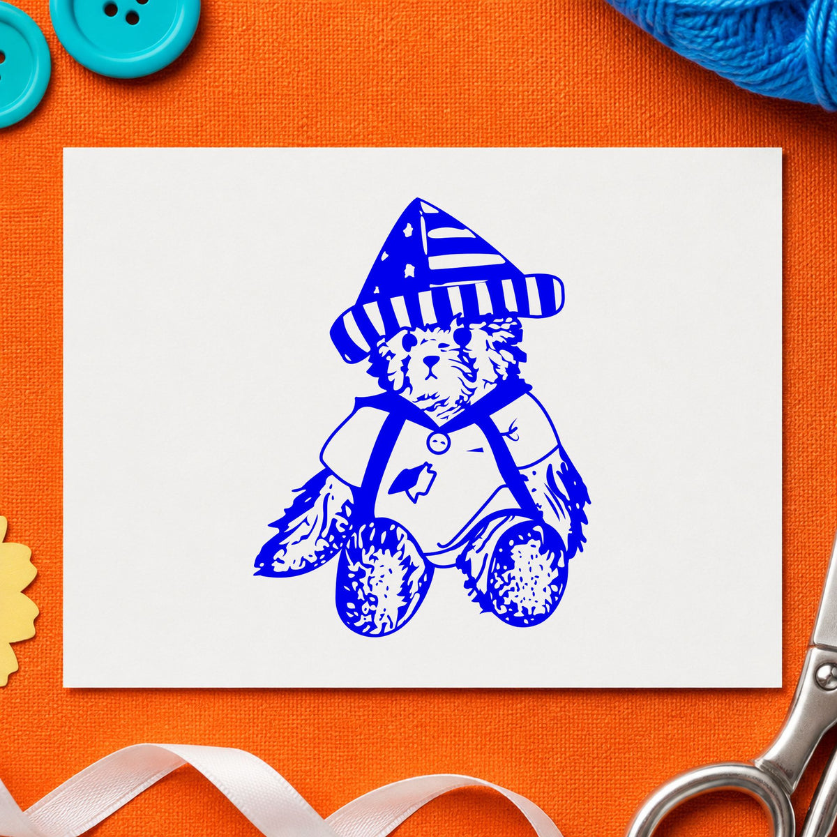Blue stars and stripes stamp impression featuring the bear in stars and stripes hat design on white paper.