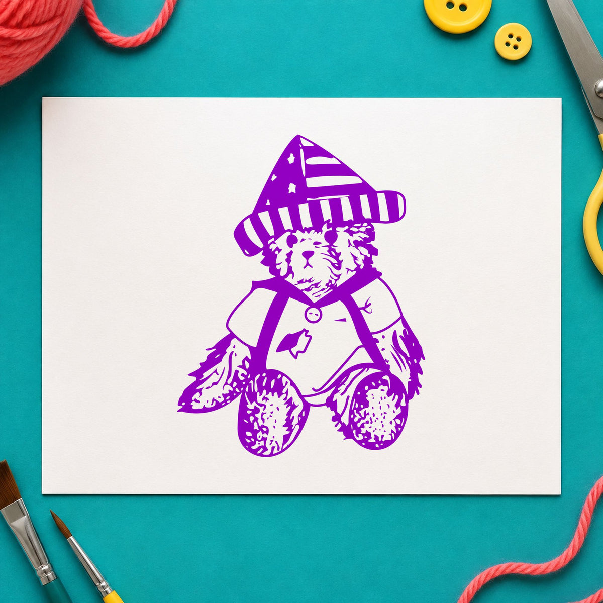 Bear in Stars and Stripes Hat Rubber Stamp impression in purple ink on white paper in a styled craft setting.