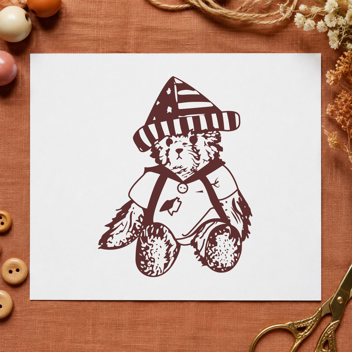 Bear in Stars and Stripes Hat Rubber Stamp impression in brown ink on white paper in a styled craft setting.
