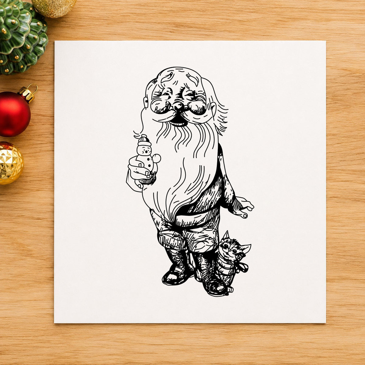Santa with Kitten and Snowman Rubber Stamp impression in black ink on white paper in a styled craft setting.