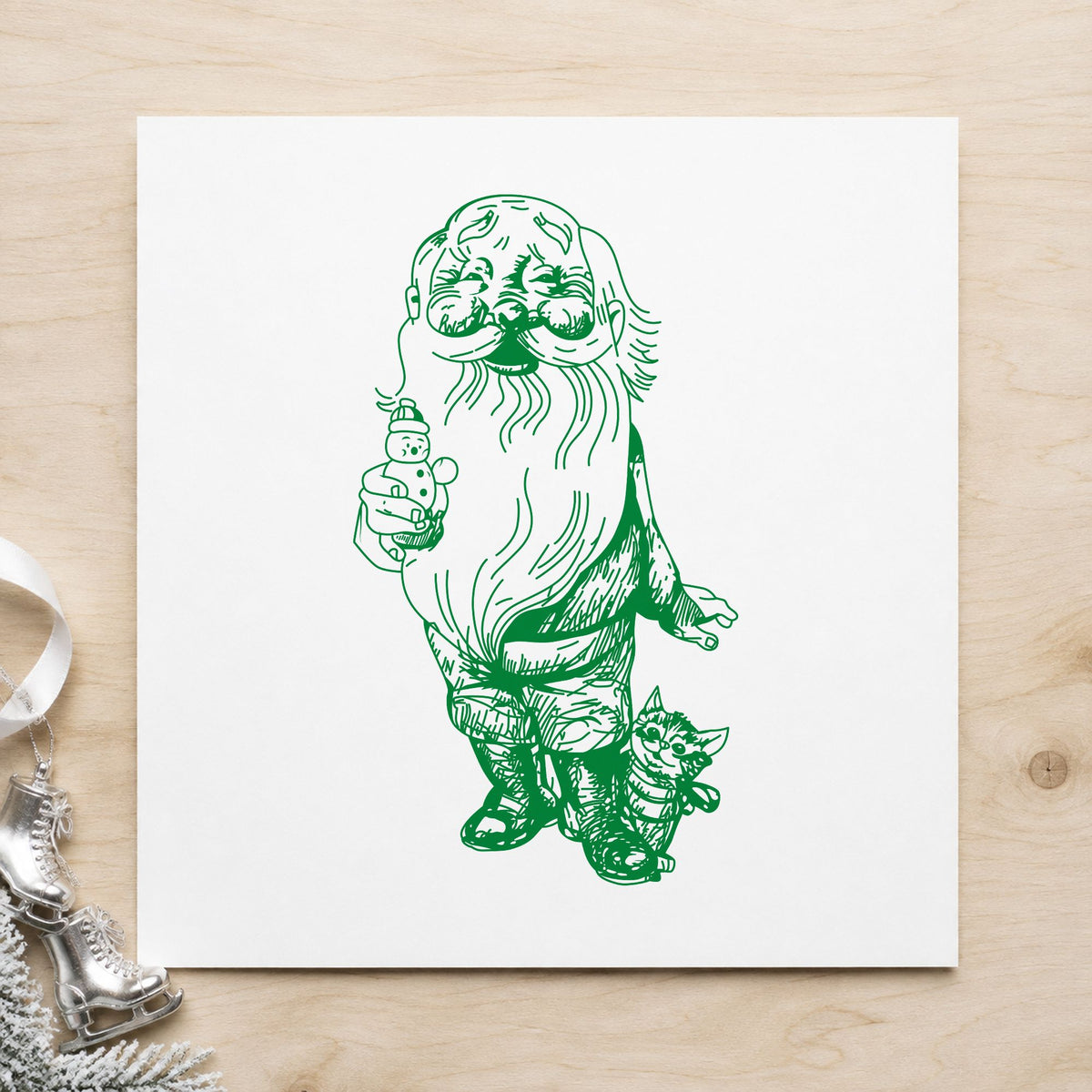 Santa with Kitten and Snowman Rubber Stamp impression in green ink on white paper in a styled craft setting.