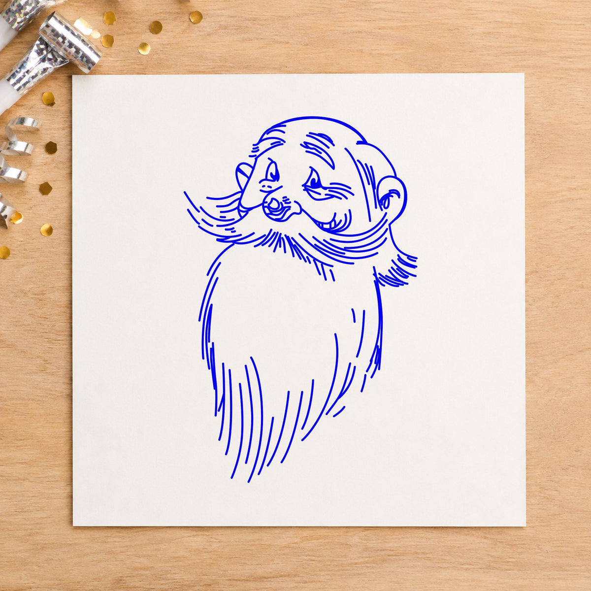 Santa Claus Face Rubber Stamp impression in blue ink on white paper in a styled craft setting.